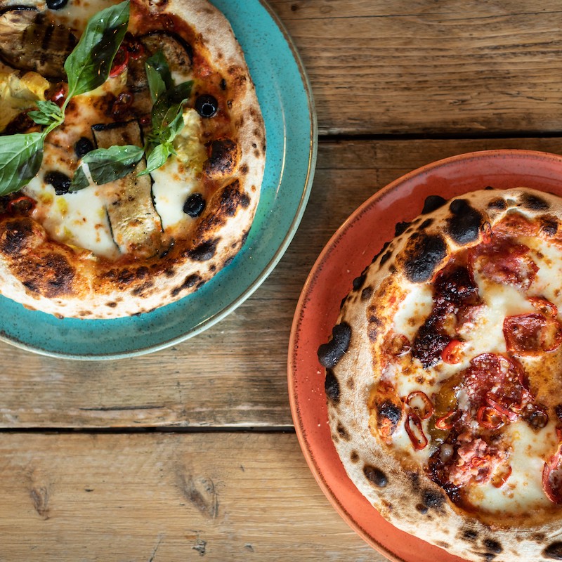 Two stone-baked Neapolitan pizzas